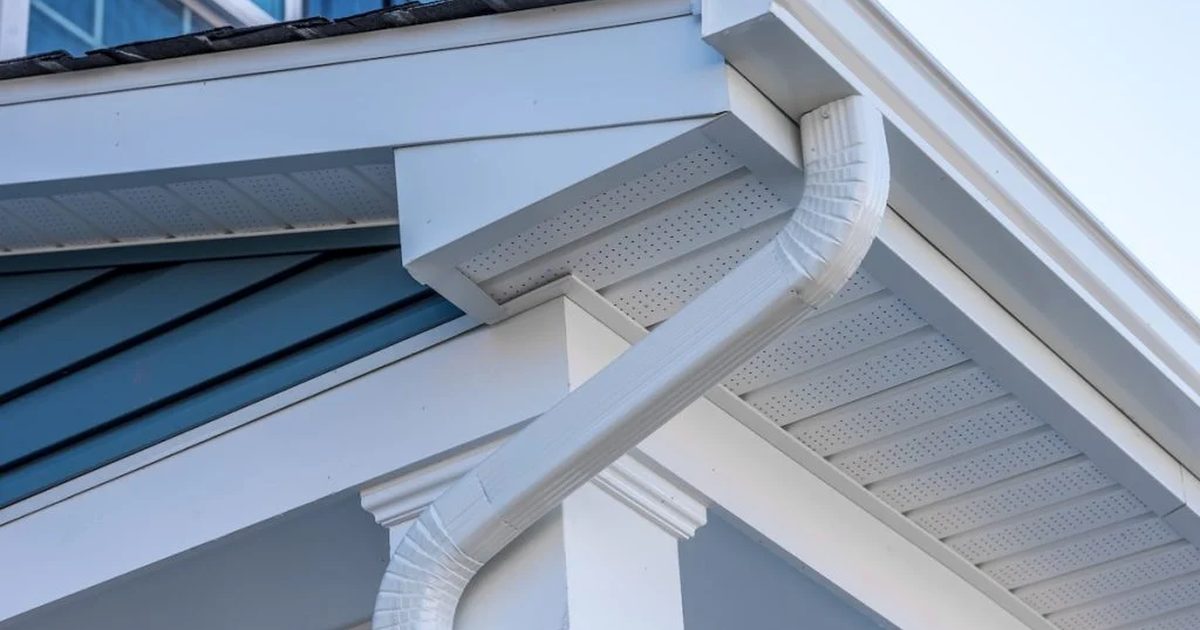White seamless gutters in a classic gutter color on a blue and white home